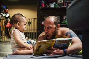 Father reading bedtime story to his son